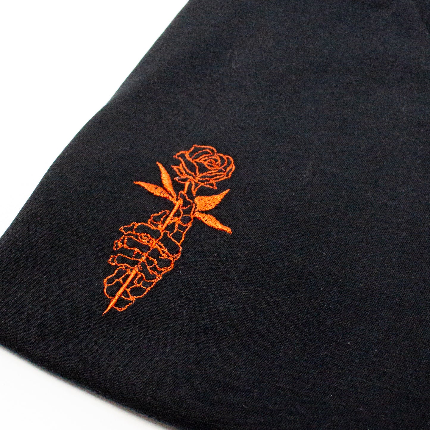 Unique Embroidered Skeletal Hand with Rose Graphic Tee - Artistic Black T-Shirt