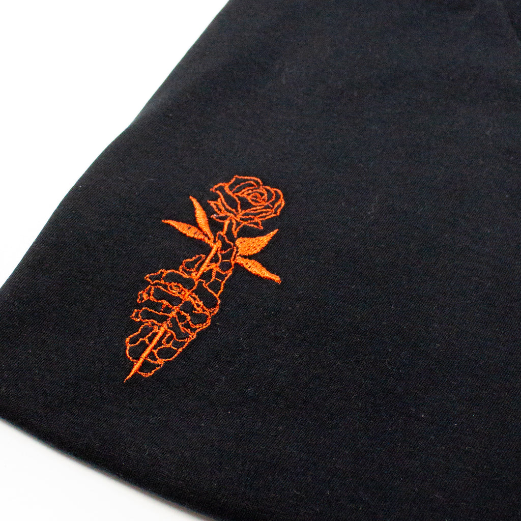 Unique Embroidered Skeletal Hand with Rose Graphic Tee - Artistic Black T-Shirt